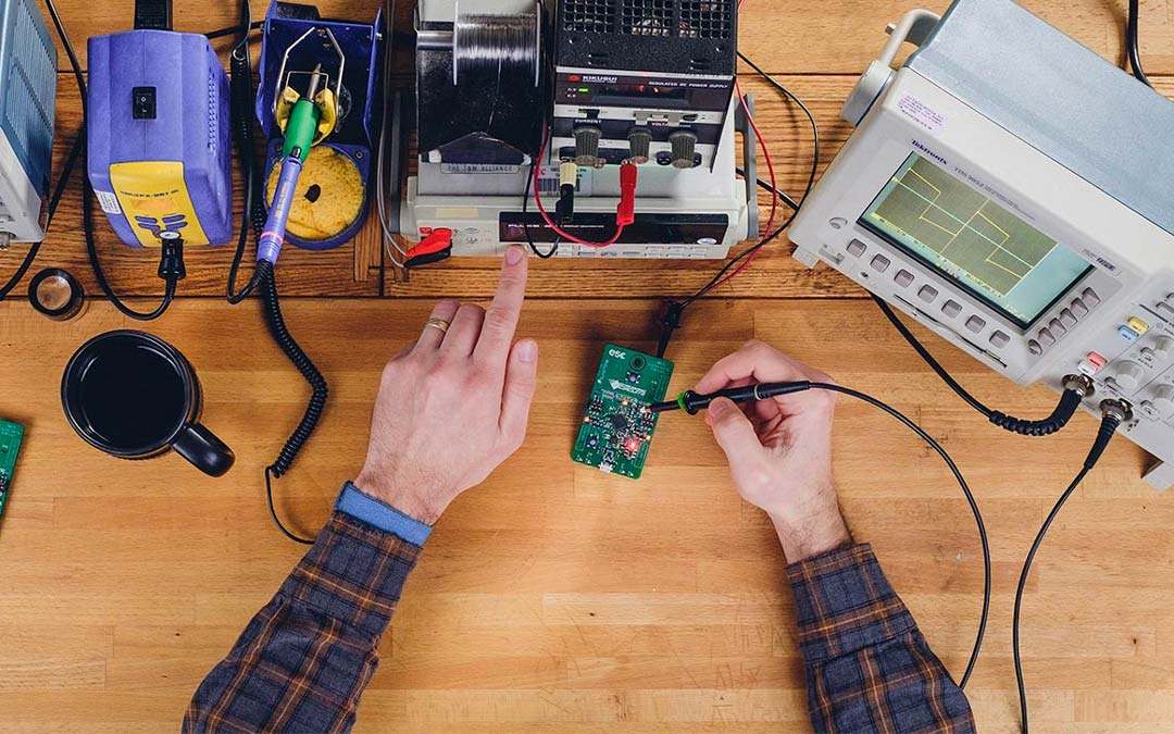 Engineer solders a circuit board